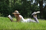 girl reading book in summer
